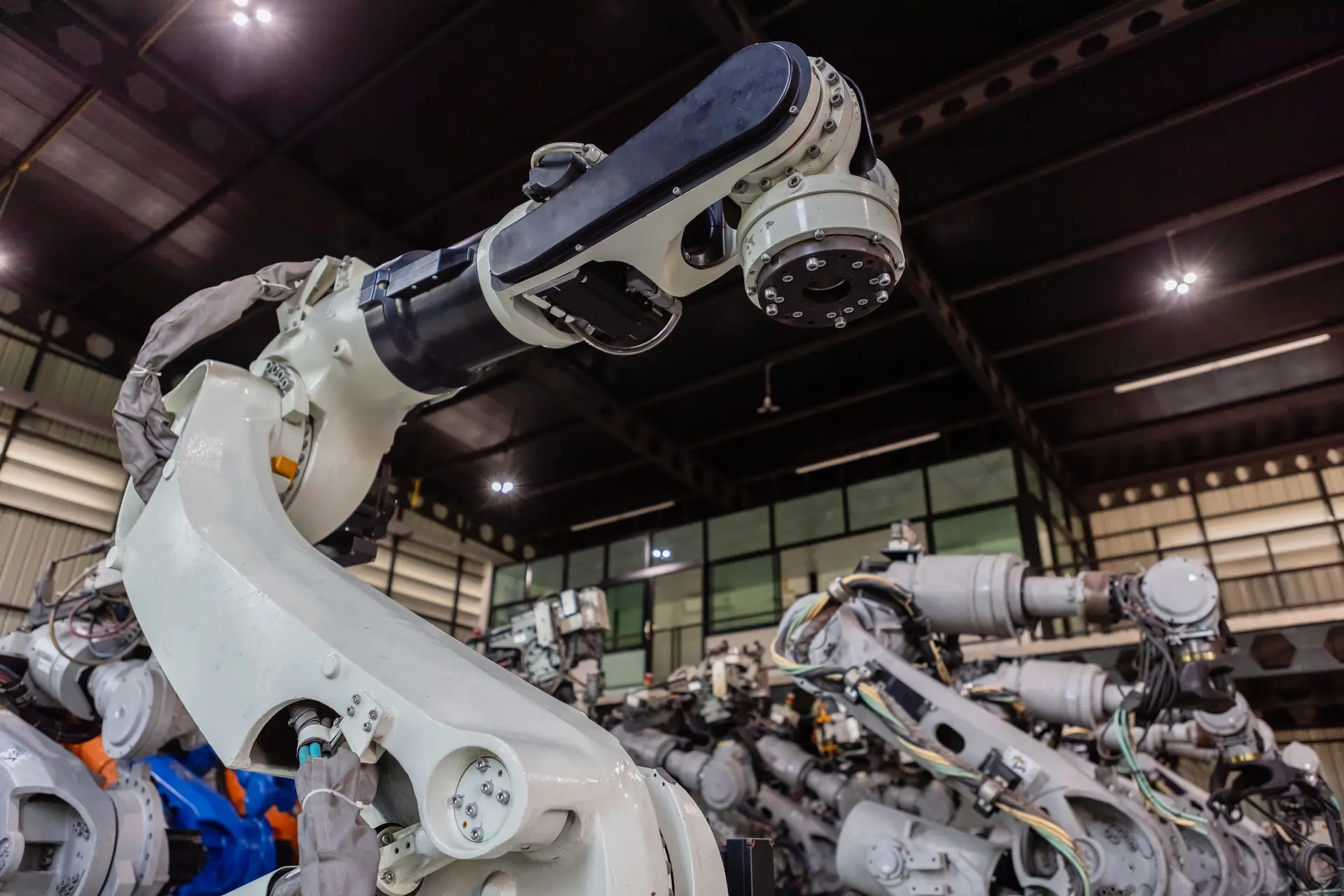 Advanced robotic arm in a modern manufacturing plant, showcasing industrial automation, precision engineering, and cutting-edge robotics technology for efficient production systems.